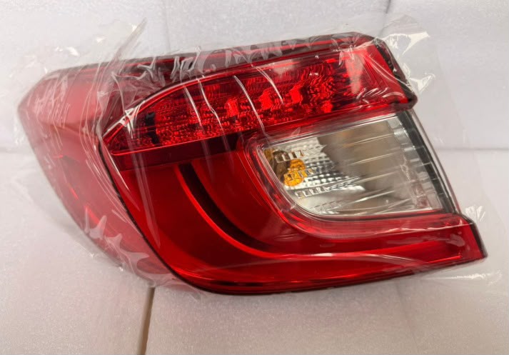 Red Honda Civic tail light assembly wrapped in plastic